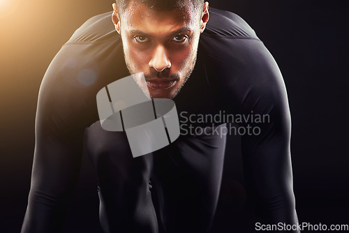 Image of Runner man, start and isolated portrait or run, race and intense focus in dark studio background. Serious, athlete and running training, cardio and fitness motivation to win, workout or exercise