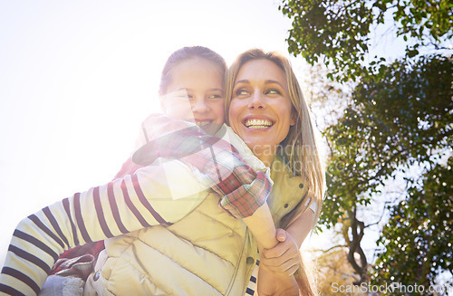 Image of Hug, piggyback and happy kid, mom or free people enjoy family time, freedom and wellness on bonding walk. Sky, sun flare and youth girl with mother, mama or woman smile for outdoor fun on Mothers Day
