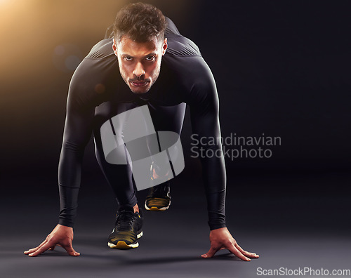 Image of Man, portrait and runner ready to start, race or intense sport focus in studio background. Serious, professional athlete and running, training or cardio motivation to win, workout or exercise mockup