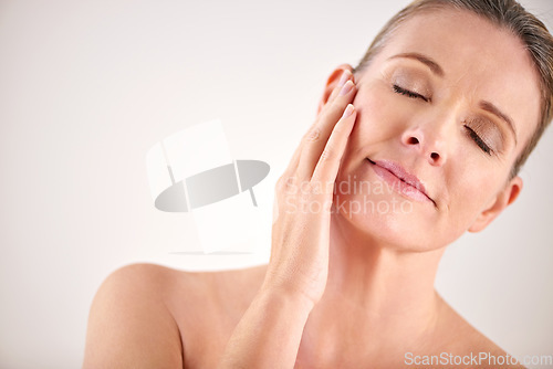 Image of Senior woman, face and cosmetic wellness or touching her perfect skin on isolated and white background. Mature lady, massaging and wrinkles in facial aging process or skincare and beauty on mock up