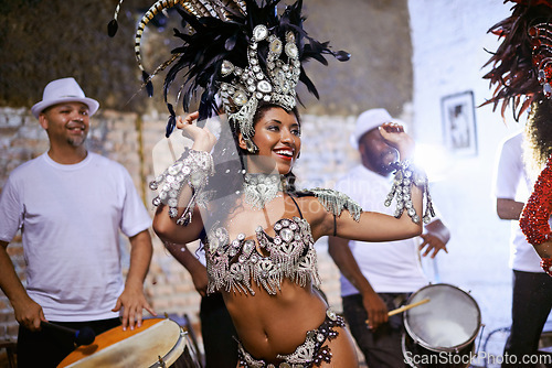 Image of Carnival, dance and cultural female dancer performing with band at mardi gras or exotic festival. Performance, costume and woman dancing with rhythm to live music for entertainment in Rio de janeiro.