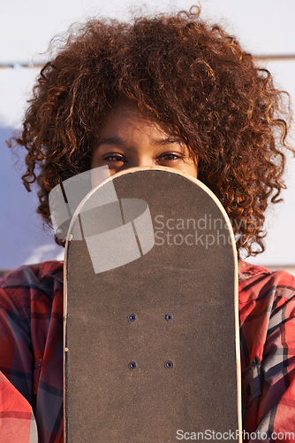 Image of Hide, face and portrait of woman with skateboard for fitness, urban and hiding in outdoors. Training, skating and youth with african female skater and cover for hipster, relax and skateboarder afro