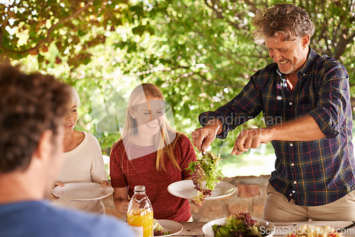 Image of Food, party and happy with family at lunch and serving for health, bonding and celebration. Thanksgiving, social and event with group of people eating together for dining, generations and wellness