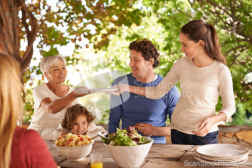 Image of Food, party and help with family at lunch in nature for health, bonding and celebration. Thanksgiving, social and event with parents and children eating together for dining, generations and wellness