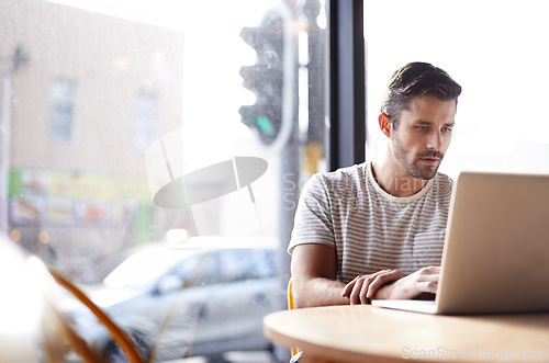 Image of Coffee shop, web connection and man with laptop and lens flare doing code work in a cafe. Tech, email and male freelancer customer at restaurant with online job and computer writing with focus