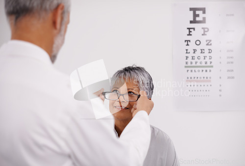 Image of Optometrist doctor, elderly patient and glasses for vision, eye exam in medical consultation at optometry practice. Prescription lens, frame and senior man help woman in clinic with health insurance