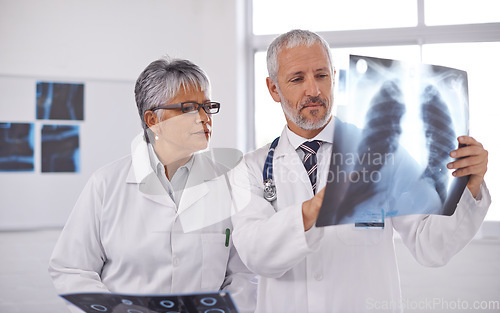 Image of Senior team of doctors, analysis of xray with surgery, people in radiology and cardiovascular health at clinic. Lung scan, old man and woman surgeon collaboration with assessment and problem solving