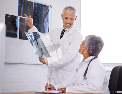 Image of Senior team of doctors, study xray for surgery and people in radiology with healthcare in clinic. Review anatomy scan, old man and woman surgeon collaboration with assessment and problem solving