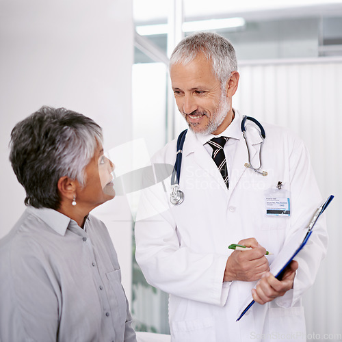 Image of Elderly man doctor with patient, clipboard for information and medical forms during consultation. Healthcare, old woman at checkup and health insurance with communication and help at doctors office