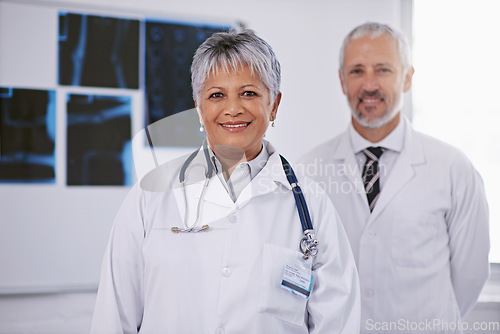 Image of Senior team of doctors in portrait, smile in radiology with woman in leadership and man in hospital. Surgeon, healthcare and medical professional people in collaboration, happy working together