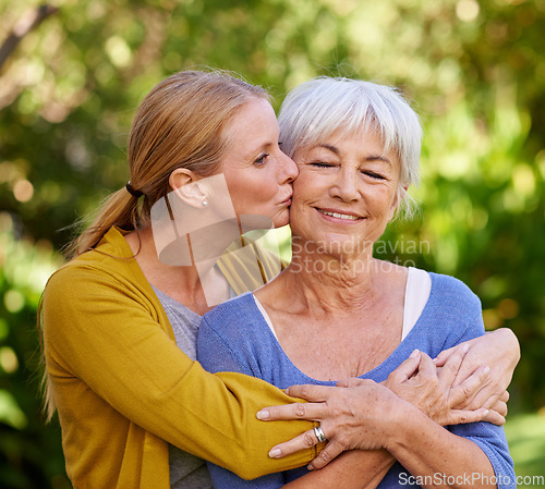 Image of Adult daughter kiss mom, hug and trust with peace outdoor, family spending quality time in garden together. Women are content in relationship with love, bonding and solidarity in nature park