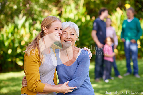 Image of Family, mother and adult daughter hug in park, spending quality time in outdoor together with happiness and care. Happy women are content in relationship with love, bonding and carefree in nature