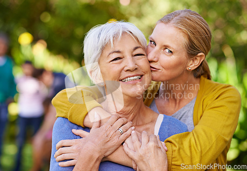 Image of Senior mother, woman and kiss in nature, outdoor and portrait with love, care and trees on holiday. Elderly mama, lady and embrace with bond, excited face and support in backyard with summer sunshine