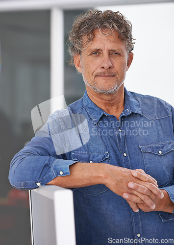 Image of Portrait, mature and business man in office with pride for career at startup. Entrepreneur, professional and male manager, confident boss and serious person from Australia leaning on computer.