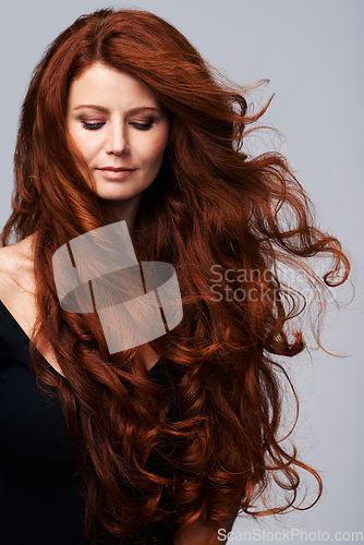 Image of Wind in hair, ginger and face of woman in studio for keratin treatment, wellness and growth on gray background. Beauty, hairdresser mockup and female model with shine, healthy and natural hairstyle