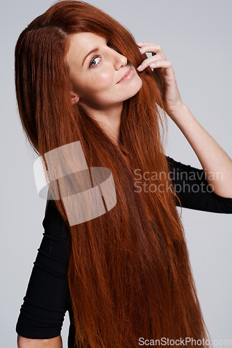 Image of Red hair, beauty and portrait of woman in studio for keratin treatment, wellness and haircare on white background. Salon, hairdresser and ginger female model with shine, healthy and natural hairstyle