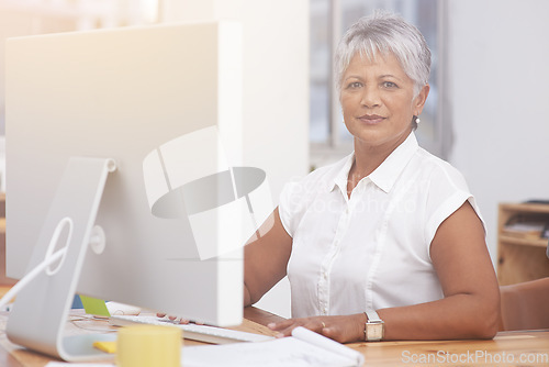 Image of Desktop, portrait and mature woman in office for online management, digital planning and working with career mindset. Confident indian person, professional worker or business employee on computer pc