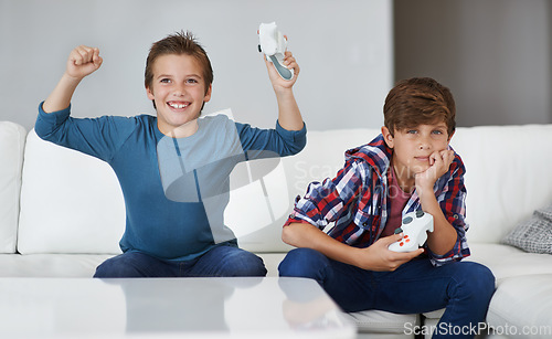 Image of Boys playing video game, celebrate and friends gaming with tech, esports and entertainment with winner. Gamer kids play games on console at home, happy with win and male children have fun together