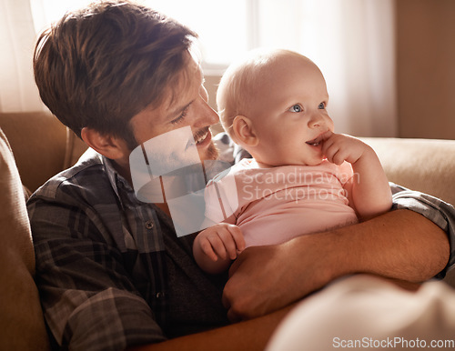 Image of Smile, dad and hug baby on sofa in home living room, playing or bonding together. Happiness, care and father embrace infant, newborn or child on couch in lounge, having fun and enjoying quality time.