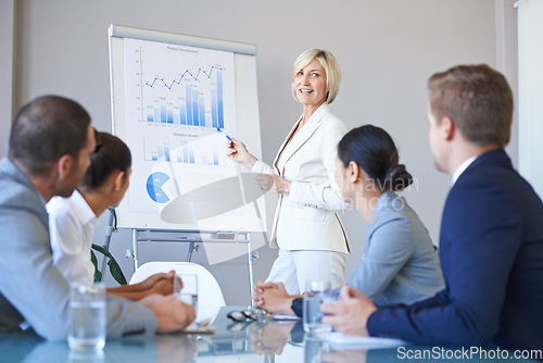 Image of People in a business meeting, presentation with data analytics and woman speaker, leadership and graphs. Analysis of research in seminar in conference room with corporate group in collaboration