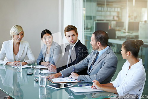 Image of People in a business meeting, teamwork and discussion in conference room with diversity in corporate group. Men, women and project planning with conversation, paperwork and collaboration in workplace