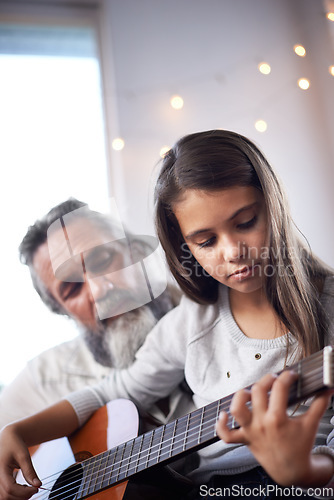 Image of Girl with grandfather, guitar and learning to play, music education and help with creative development. Musician, art and old man helping female kid learn focus and skill on musical instrument