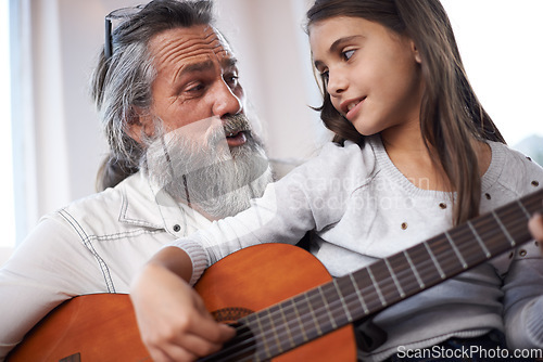 Image of Grandfather teaching girl to play guitar, learning and development in music with help in creativity. Musician, art and senior man helping female kid learn focus and skill on musical instrument