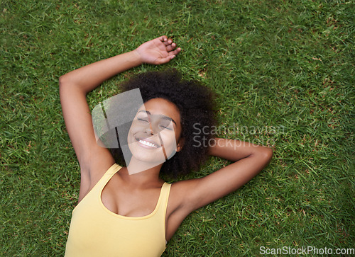 Image of Sleeping, grass and mockup with a black woman lying on a field from above for peace or quiet outdoor in nature. Dream, relax and zen with an attractive young female resting alone in the countryside