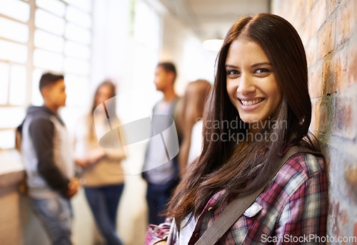 Image of Learning, smile and portrait of woman in college hallway for studying, education and scholarship. Future, happy and knowledge with student leaning on brick wall for university, break on campus