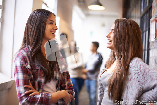 Image of Girl friends, university and hallway talking with happiness and discussion together. Happy teenager, college and school communication of young and gen z students on campus for education joke or class