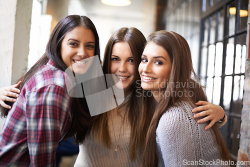 Image of University, friends and portrait of women hug on campus for studying, education and learning together. Friendship, scholarship and happy female students smile in school, academy and college hallway