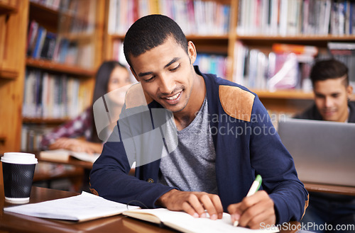 Image of Study, writing and smile with man in library for education, research and classroom quiz. Focus, learning and notebook with male student on university campus for knowledge, scholarship and project