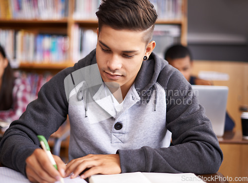 Image of Learning, writing and college with man in library for education, research and classroom quiz. Focus, study and notebook with male student on university campus for knowledge, scholarship and project