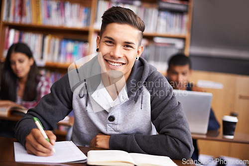 Image of Education, writing and happy with portrait of man in library for study, research or classroom quiz. Focus, learning and notebook with male student at university for knowledge, scholarship and project