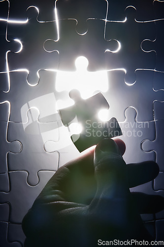 Image of Hand, missing jigsaw puzzle and glow with light for problem solving, ideas and connection. Person, brain power and games with strategy, innovation or synergy for solution, link or creativity for goal