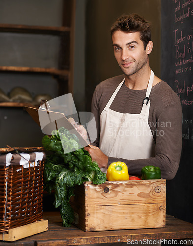 Image of Chef, clipboard and portrait of man in restaurant with vegetables for vegetarian or vegan ingredients. Happy, male cook with checklist and food from Norway for cooking in kitchen or small business.