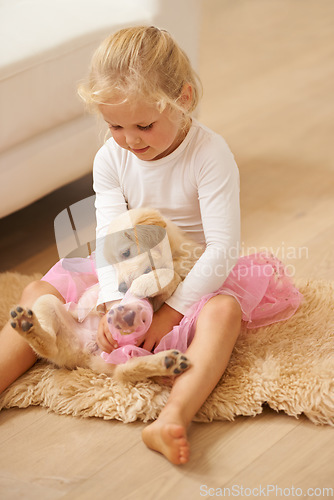 Image of Child, golden retriever and playing at home with a dog and happy girl together for love, care and development. Cute kid and animal puppy or pet playing dress up game as friends on the lounge floor