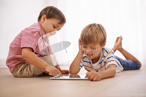 Image of Learning, tablet and happy children playing together in family home for fun and education. Boy kids or friends on floor to play or streaming internet for development with mobile app, game and video