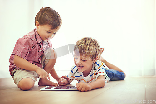 Image of Children, tablet and learning together in family home for fun and education. Male kids or friends laugh on floor while streaming internet for development with mobile app, online game or funny video