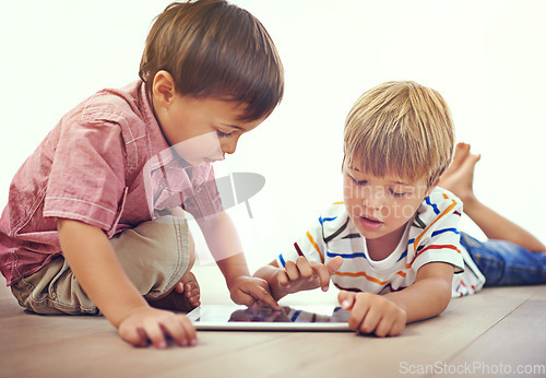 Image of Tablet, learning and children playing together in family home for fun and education. Male kids or friends on floor to play and streaming internet for development with app, game and online video