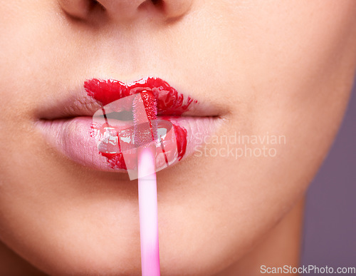 Image of Closeup of woman lips, red lipstick and brush, makeup and beauty isolated on studio background. Vibrant aesthetic, creativity and mouth of female model with cosmetic product, cosmetology and lipgloss