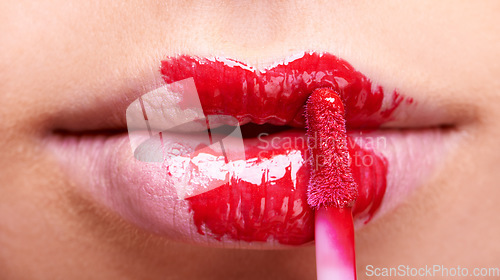 Image of Woman lips, red lipstick and brush, makeup and beauty closeup with bold color and cosmetics. Vibrant aesthetic, creativity and mouth of female model with cosmetic product, cosmetology and lip gloss