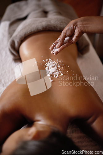 Image of Salt sprinkle, back scrub and spa specialist hands with woman customer at a hotel with massage. Exfoliate therapy, luxury and relax treatment of a female person rest for skincare and wellness