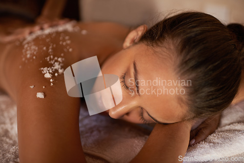 Image of Spa, relax and holistic body massage of a woman with beauty specialist with salt treatment. Exfoliate, female person back and detox application for skin and calm wellbeing at a hotel with care