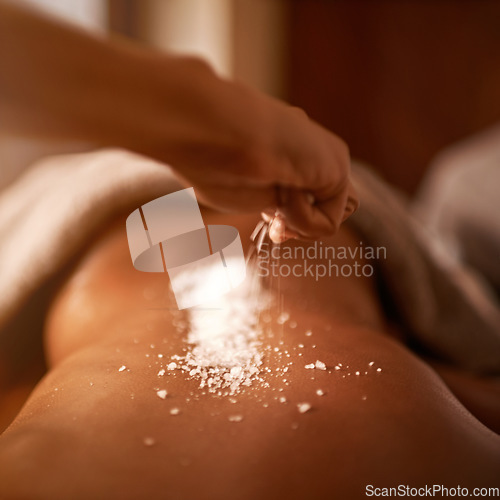 Image of Spa, back and hands with salt massage of a woman with beauty specialist with treatment. Exfoliate, female person skincare and relax detox application for skin and calm wellbeing at a hotel with care