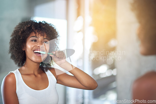 Image of Mirror, dental and black woman brushing teeth, fresh breath and oral health in the bathroom. Female person, happy model and lady with wellness, mirror and hygiene with morning routine and tooth care