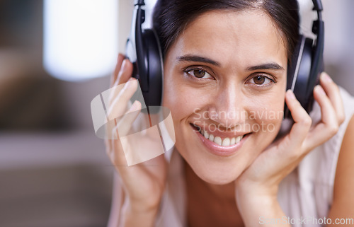 Image of Happy woman, portrait and headphones listening to music with smile for free time, comfort or relaxing at home. Closeup of female face smiling in living room with headset for audio sound track indoors