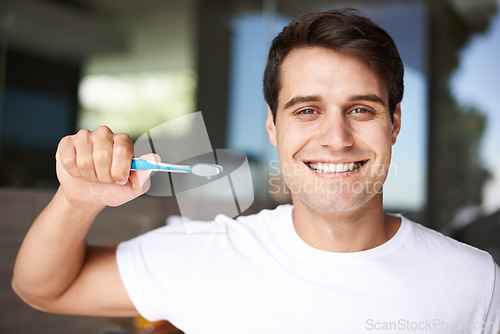 Image of Brushing teeth, man portrait and cleaning in a bathroom at home for oral hygiene and health. Smile, dental and toothbrush with a male person with happiness in the morning at a house with care