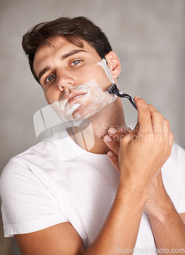 Image of Cleaning, shaving and portrait of man in bathroom for facial grooming, wellness and cosmetics at home. Health, skincare and male person shave for face hygiene, self care and hair removal with razor