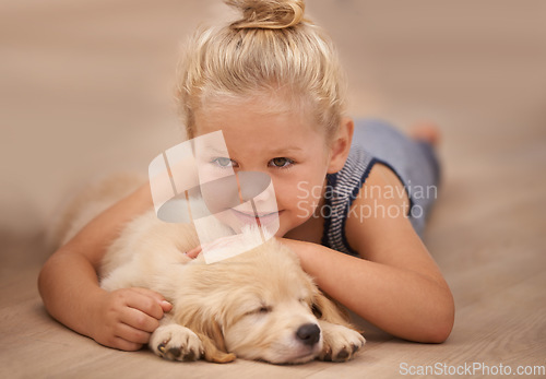 Image of Girl kid hug her puppy, relax at home and happy with sleeping golden retriever dog and child with smile. Happiness, pet care and love with young female and her domestic animal lying on wood floor